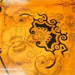 20th-Century Louis XVI-Style satinwood and penwork circular table or pair of console tables, the circular quarter-veneered top decorated in penwork with a central classical mask head motif within scrolling foliate and anthemion ornament on a contrasting black ground, above a conforming frieze decorated with Greek key-type scrolls. Raised on square tapering legs, each with an upper block panel decorated with compass-star motifs.