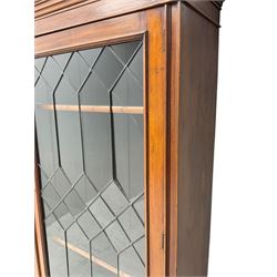 Early 20th century walnut display cabinet, projecting moulded cornice over two lead glazed doors, the interior fitted with three adjustable shelves, on cabriole supports