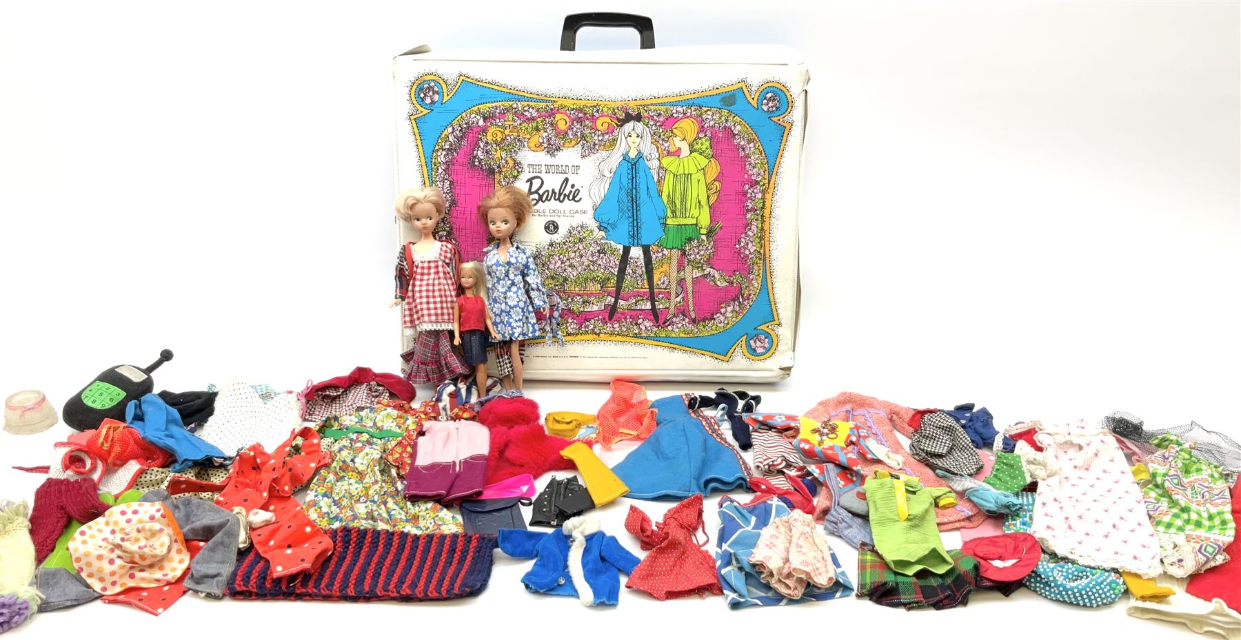The World of Barbie Double Doll Case containing a quantity of assorted doll's clothing; together with two large and one small fashion dolls.