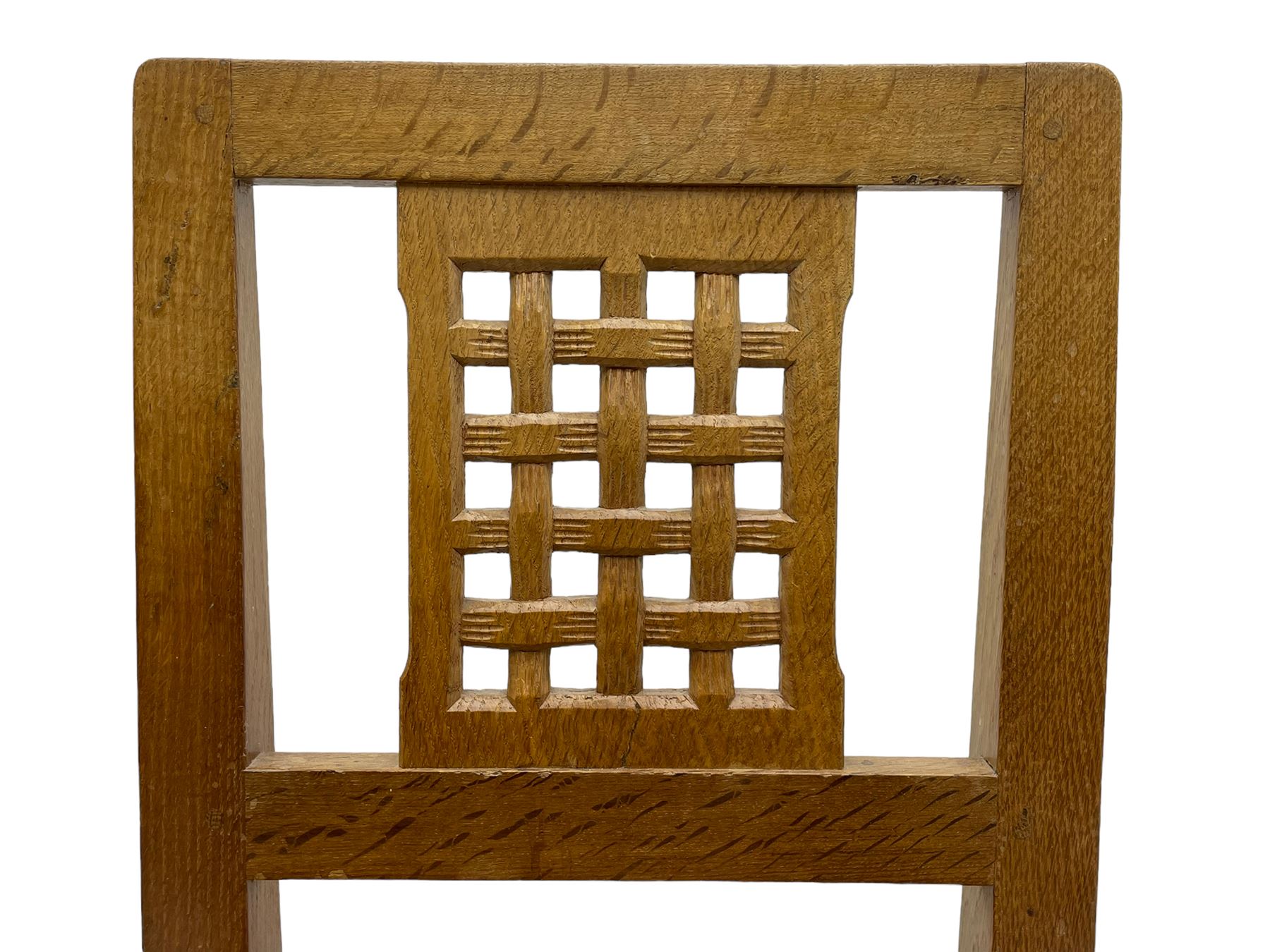 Rabbitman - set of six (4+2) oak dining chairs, carved and pierced lattice back, tan leather upholstered seat with stud band, on octagonal supports united by H-stretchers, carved with rabbit signature, by Peter Heap, Wetwang 