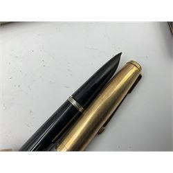 Three parker fountain pens, one example with 14ct gold plated cap and personal engraving, in Parker 51 box, together with a silver Sampson Mordan Everpoint propelling pencil with personal engraving and a silver cased fountain pen with 14ct gold nib and a souvenir bronze Dollfus-Mieg medallion, awarded to John G Sedorski, in fitted case 