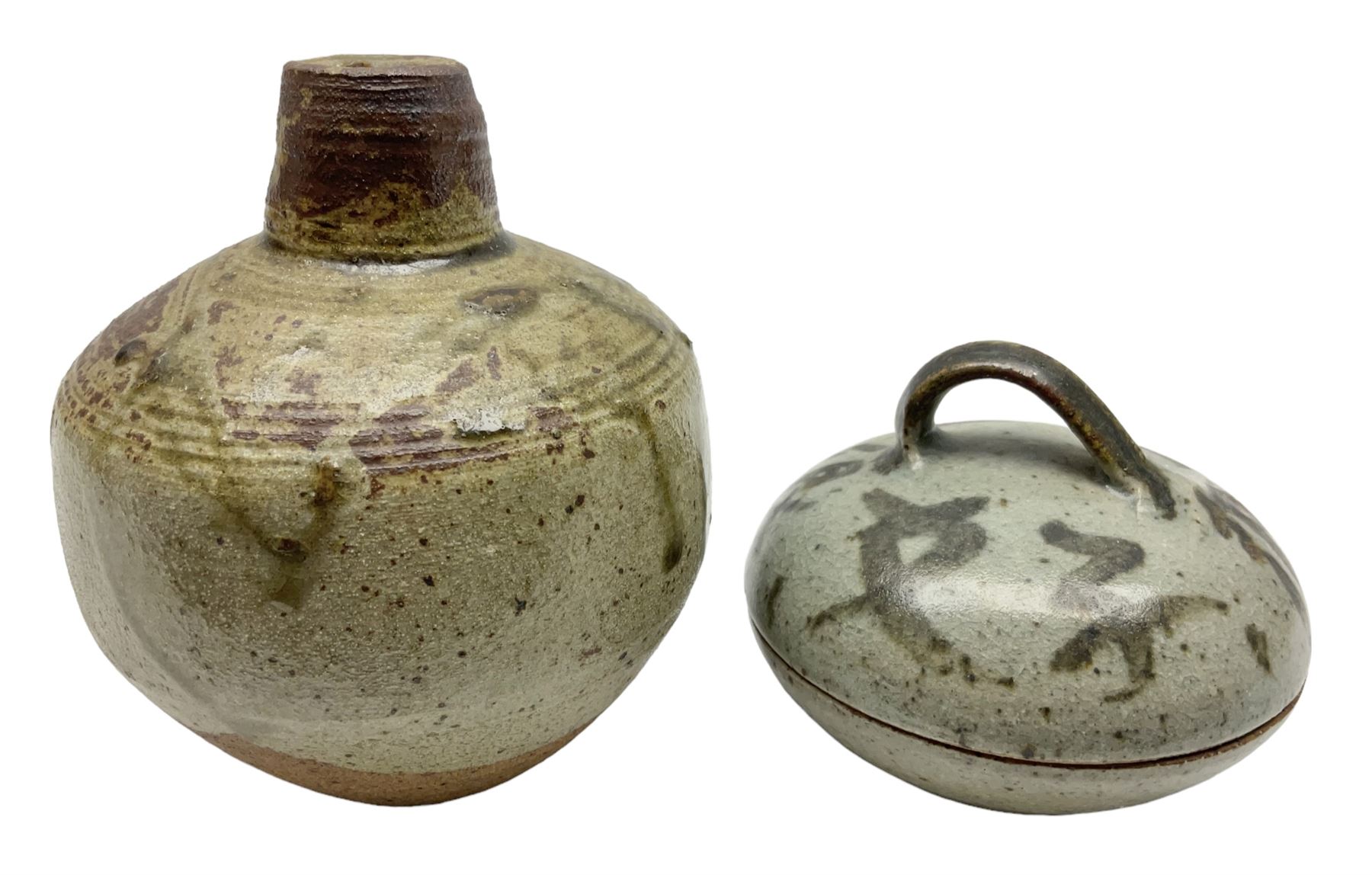 Janet Leach (American, 1918-1997) for Leach Pottery; speckled studio pottery vase of shouldered ovoid form with speckled brown decoration and trailing green and brown glaze upon beige and brown ground, with impressed J.L. monogram and Leach Pottery mark beneath, together with a Jeremy Leach blue speckled lidded circular dish with loop handle, impressed J.L, tallest H11cm