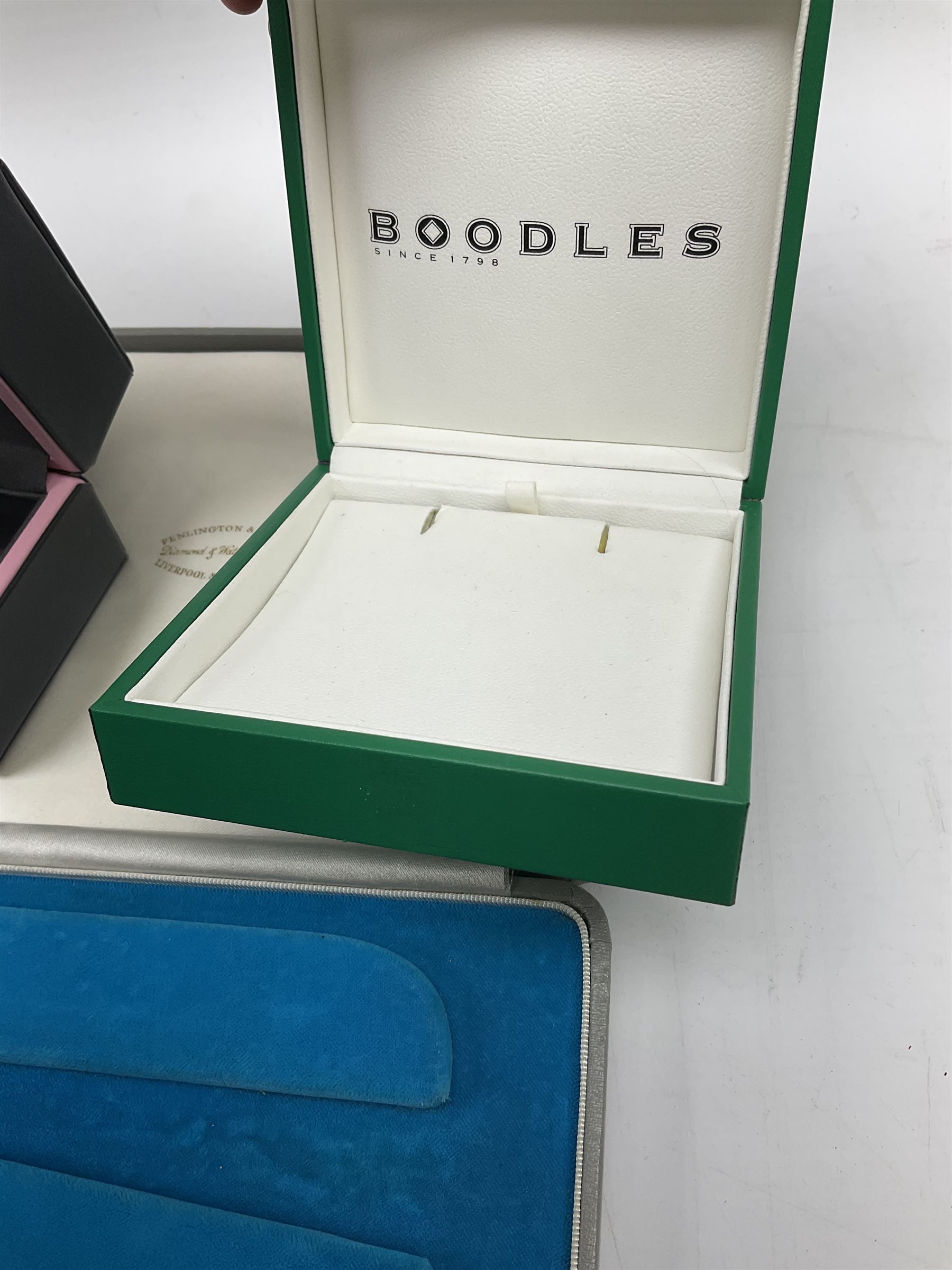 Collection of jewellery boxes including a vintage Boodle & Dunthorne bracelet box, two modern Boodles boxes, two Cartier Santos 701 sunglasses cases, one other Cartier box, Harrods cufflink/ring box and a Penlington & Batty necklace box (8)