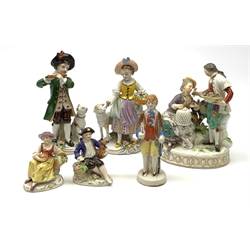 A pair of Sitzendorf porcelain figures, the first modelled as a boy playing the flute, with dog seated at his feet, the second modelled as a girl with basket of flowers and sheep stood beside her, each upon oval gilt detailed base, each with printed mark beneath, H17cm, together with a Naples figure group, a pair of small Sitzendorf figurines, and a later example marked Japan. (6). 