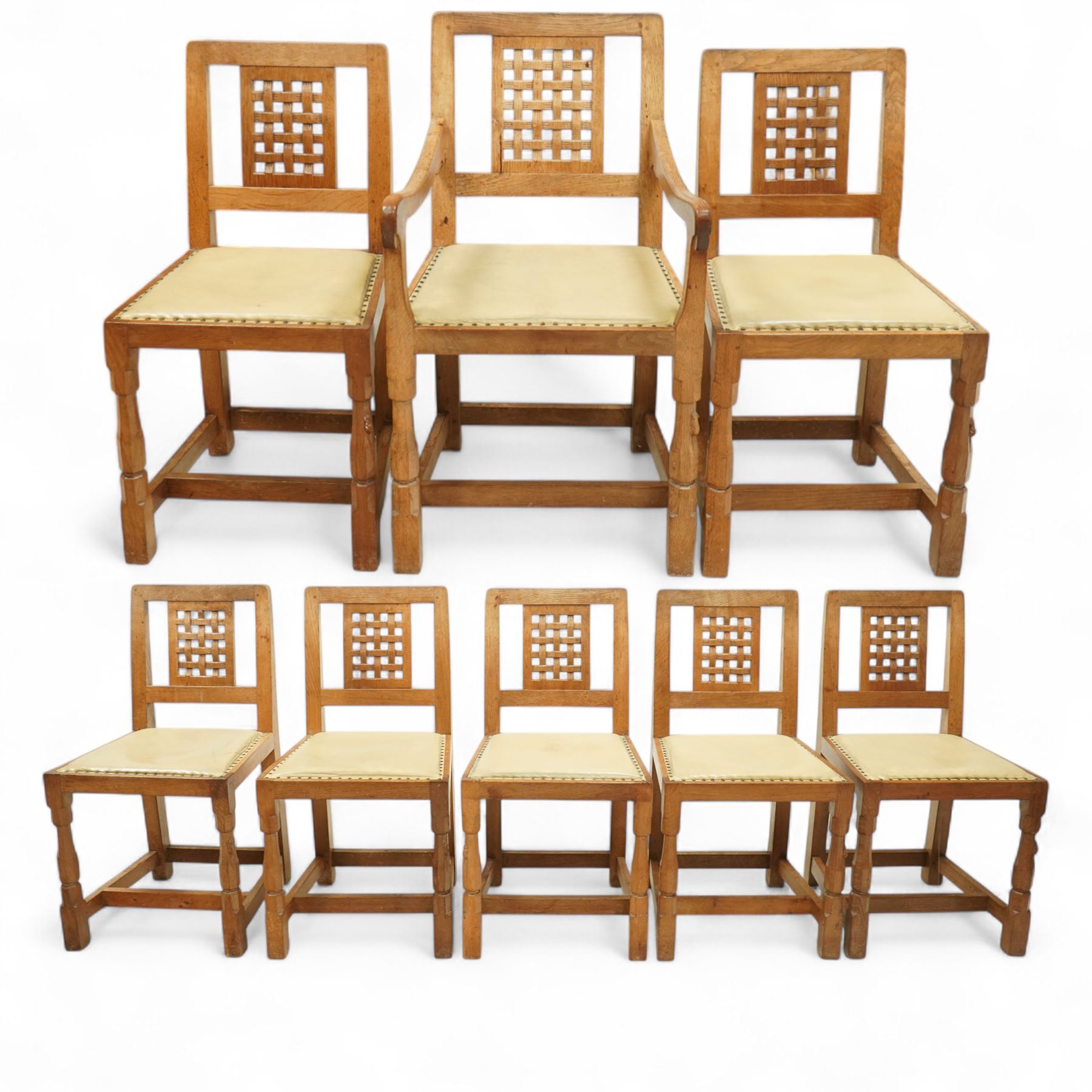 Mouseman - set of eight (7 + 1) oak dining chairs, pierced and carved lattice back over leather upholstered seat, on octagonal front supports united by stretchers, carved with mouse signature, by the workshop of Robert Thompson, Kilburn
