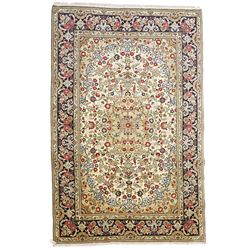 Central Persian Kashan hand-knotted carpet, ivory ground with a central floral medallion w...