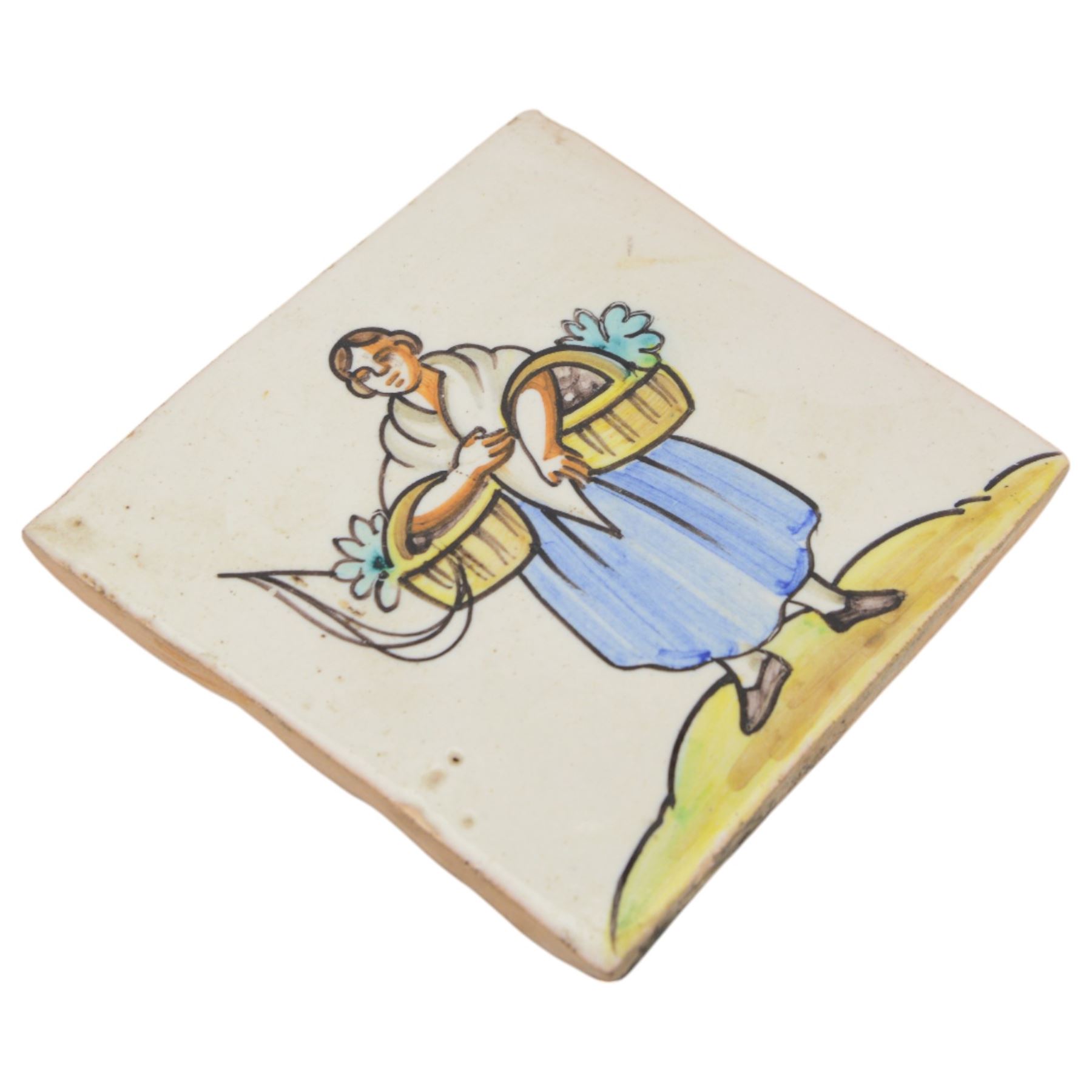 Pair of 20th century continental tin glazed tiles, of a man and a woman in traditional dress, H15cm