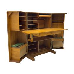 Mid-20th century walnut 'Magic Box' design metamorphic desk cabinet, two doors open to reveal sliding desk with drop leaves, document divisions and internal lamp, on sledge supports 