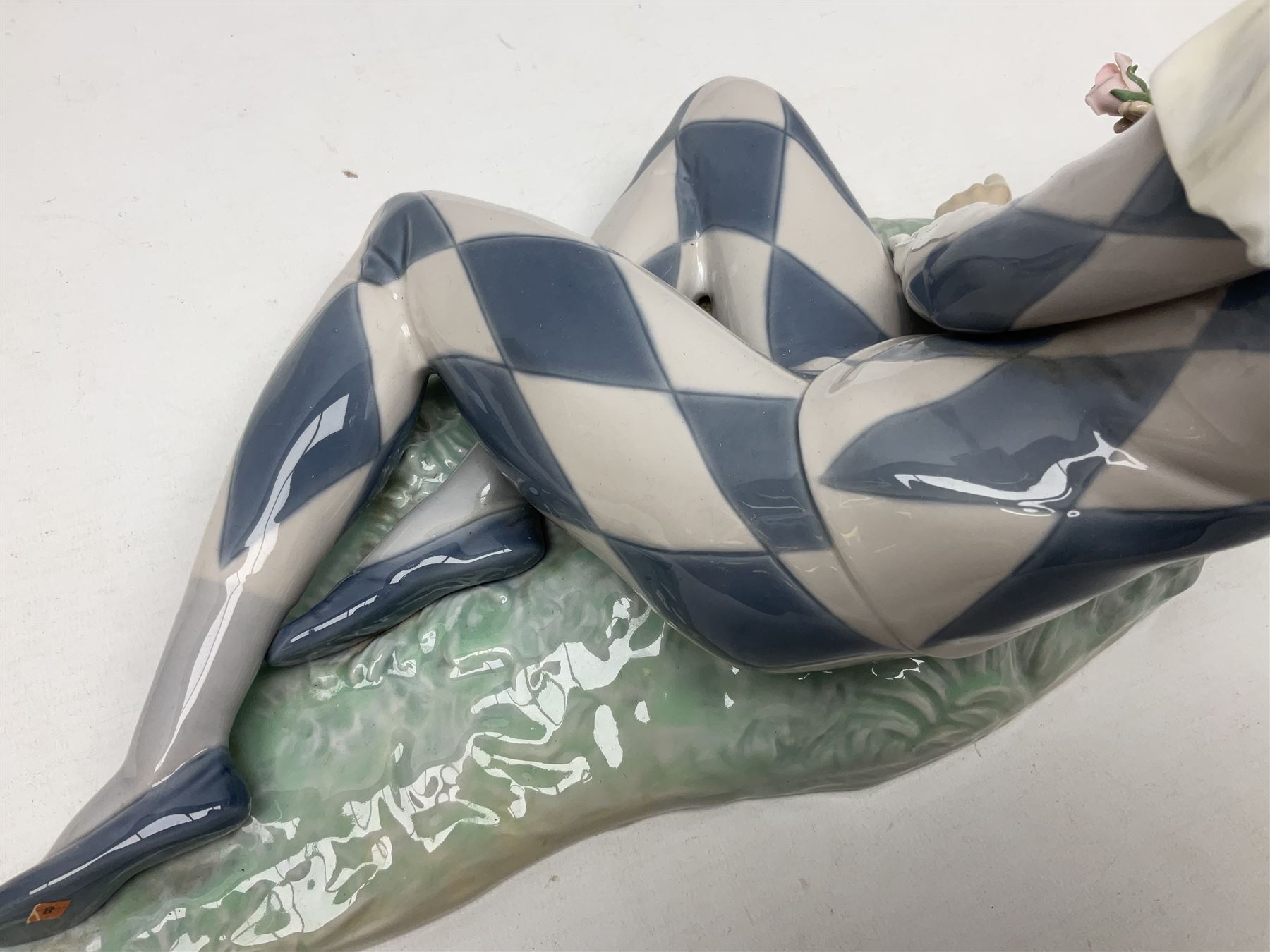 Lladro figure, Harlequin Reclining, modelled as a recumbent harlequin, no 5128, Sculpted by Salvador Furio, year issued 1982, year retired 1987, H28cm 