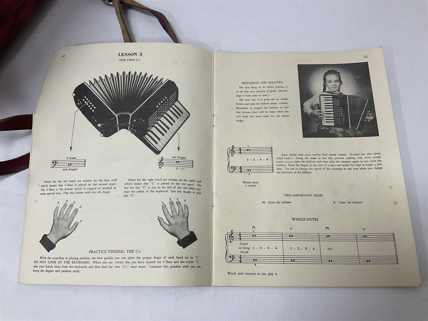 German Hohner student II compact accordion with 26 keys and 12 bass registers in a hard case With tutor