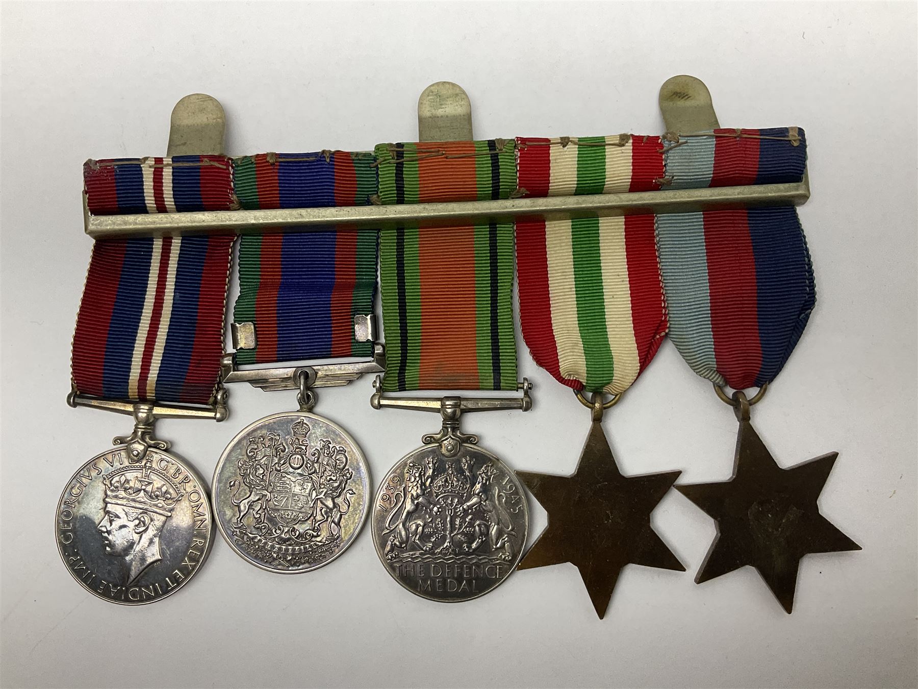 WW2 group of five medals comprising 1939-1945 War Medal, Defence Medal, 1939-1945 Star, Italy Star and Canadian Volunteer Service Medal with maple leaf clasp; all with ribbons on wearing bar; group of five matching miniatures; with extensive archive of photocopied research material relating to 2nd Lieu.(later Capt.) Richard Charles Osborne O'Hagan of the 6th Hussars and inscribed photograph of Capt. O'Hagan in uniform
