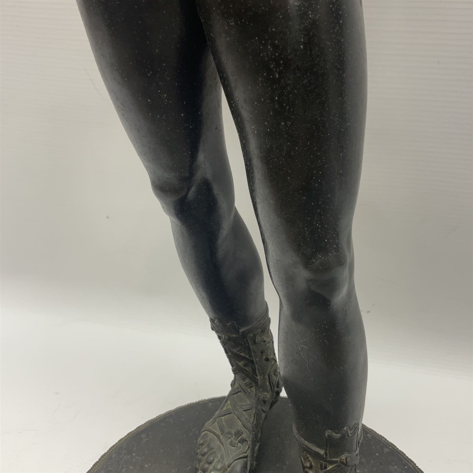 Bronzed classical nude male figure, upon a stepped circular base, H61cm 