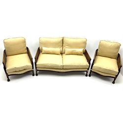 Early 20th century mahogany framed Bergere settee, double cane sides with acanthus carved arms on hairy paw feet, upholstered in a pale gold fabric (W145cm) and two matching armchairs (W66cm)
