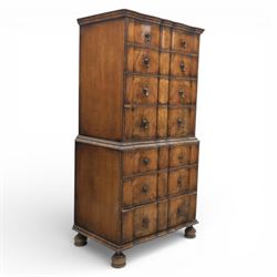 Early 20th century Queen Anne revival walnut chest on chest, the shaped cornice over an arrangement of four long drawers above three further long drawers, figured walnut veneers with feather banding and crossbanding, on turned bun supports