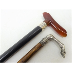  Late Victorian ebonised waling stick with cherry amber style handle and silver collar, Chester, 1897, L90cm and a Partridge wood cane with cast handle modelled as a horse's knee and hoof (2)  