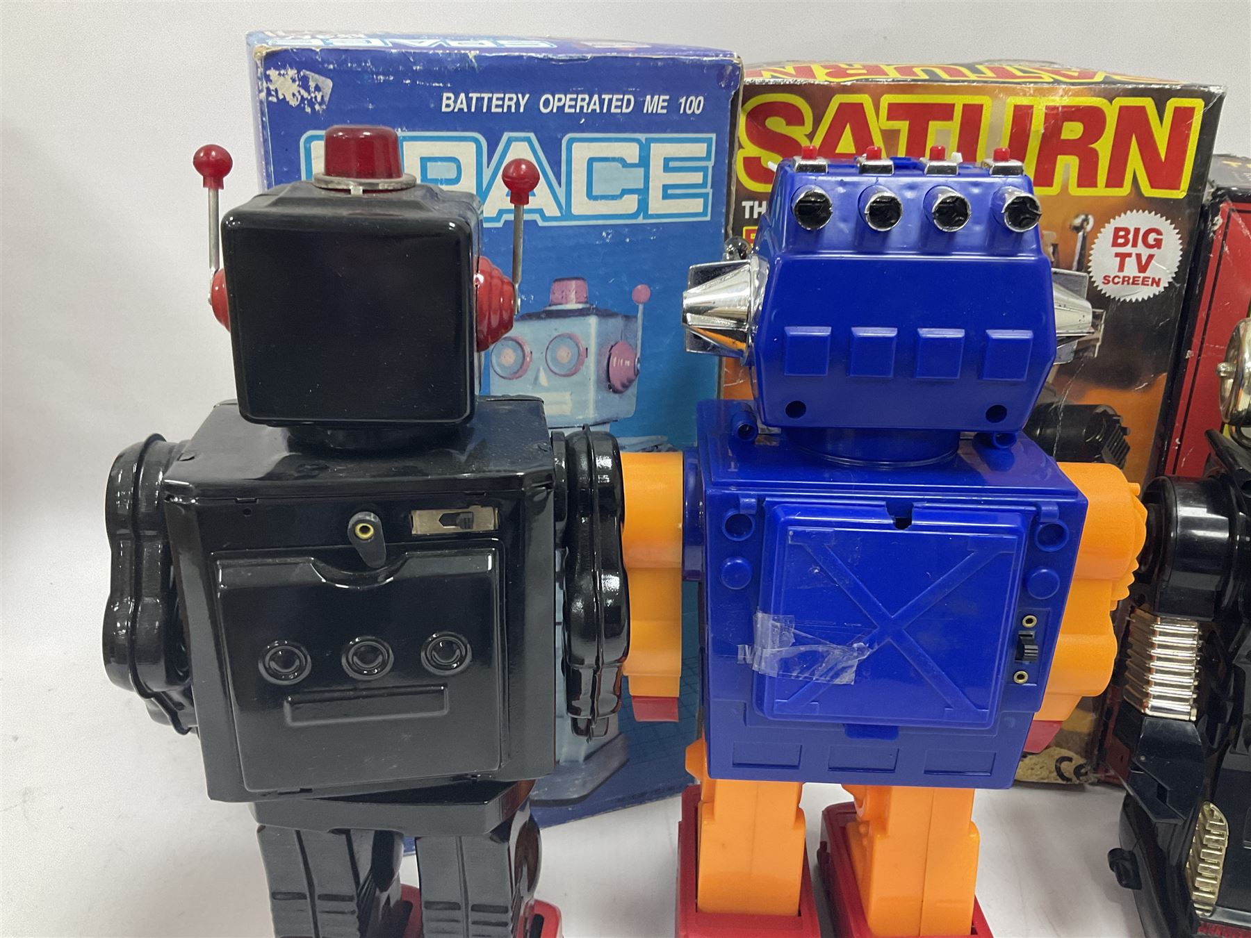 Three vintage battery operated robots comprising tin-plate Space Walk Man ME 100 Robot, Saturn the 13