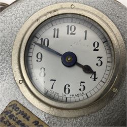 Metal cased drum shaped travelling clock with grey hammered finish, French clockwork movement and stitched leather outer case with shoulder strap; bears manuscript label 'Royal Armament Research and Development Establishment - serial no.09433' D13cm overall