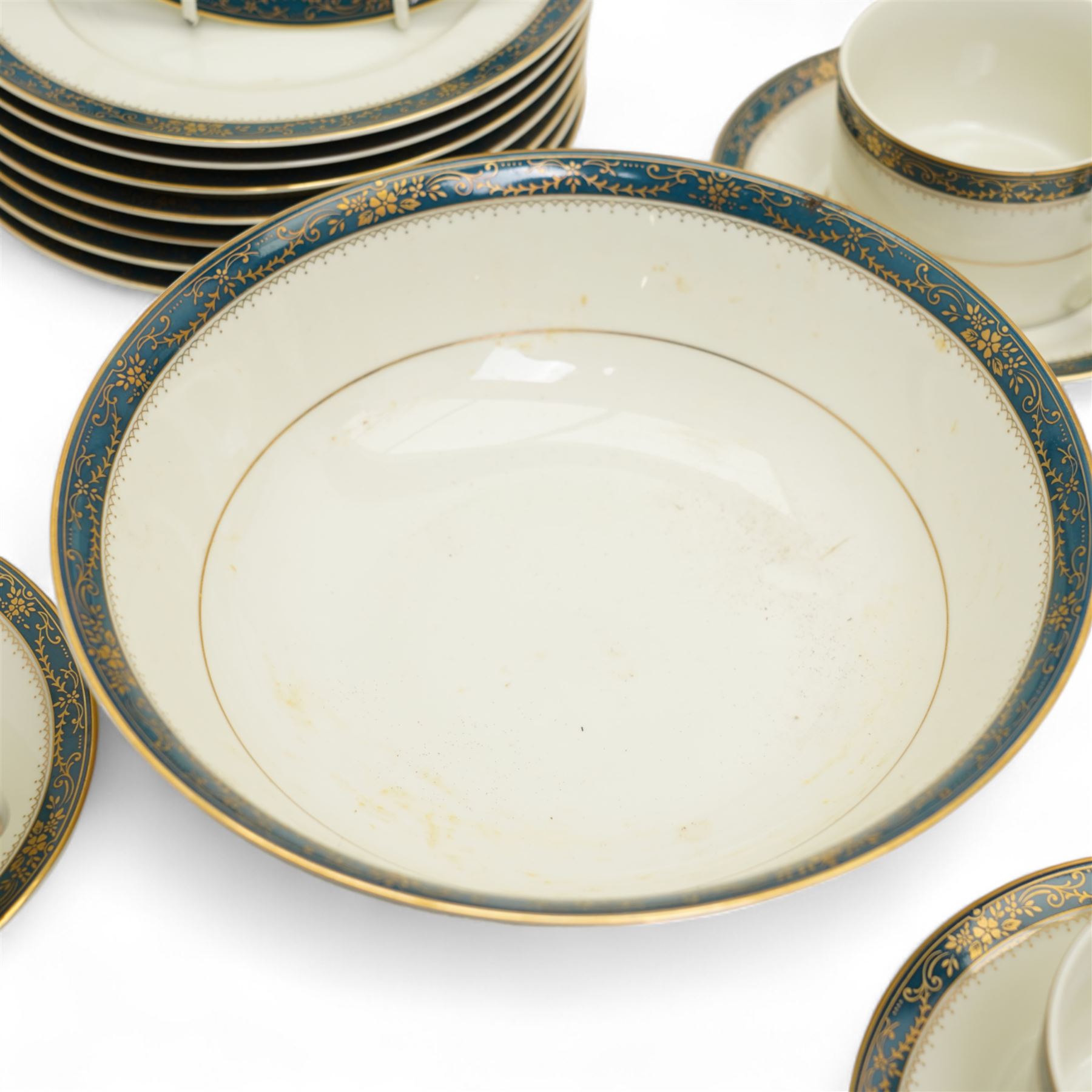 Japanese tea and dinner service retailed by Gazzaz, decorated with blue boarders and heightened with gilt foliate motifs, comprising eight teacups, eight saucers, coffee pot, sucrier, milk jug, eight cake plates, eight soup bowls, eight dinner plates etc