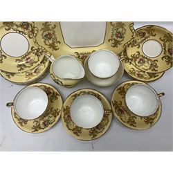 Aynsley tea service for six, decorated with floral sprays in ornate gilt detailing on cream ground, comprising six teacups and saucers, open sucrier and milk jug and cake plate, all with printed marks beneath