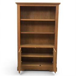 Light oak open bookcase fitted with three shelves, two cupboards, below