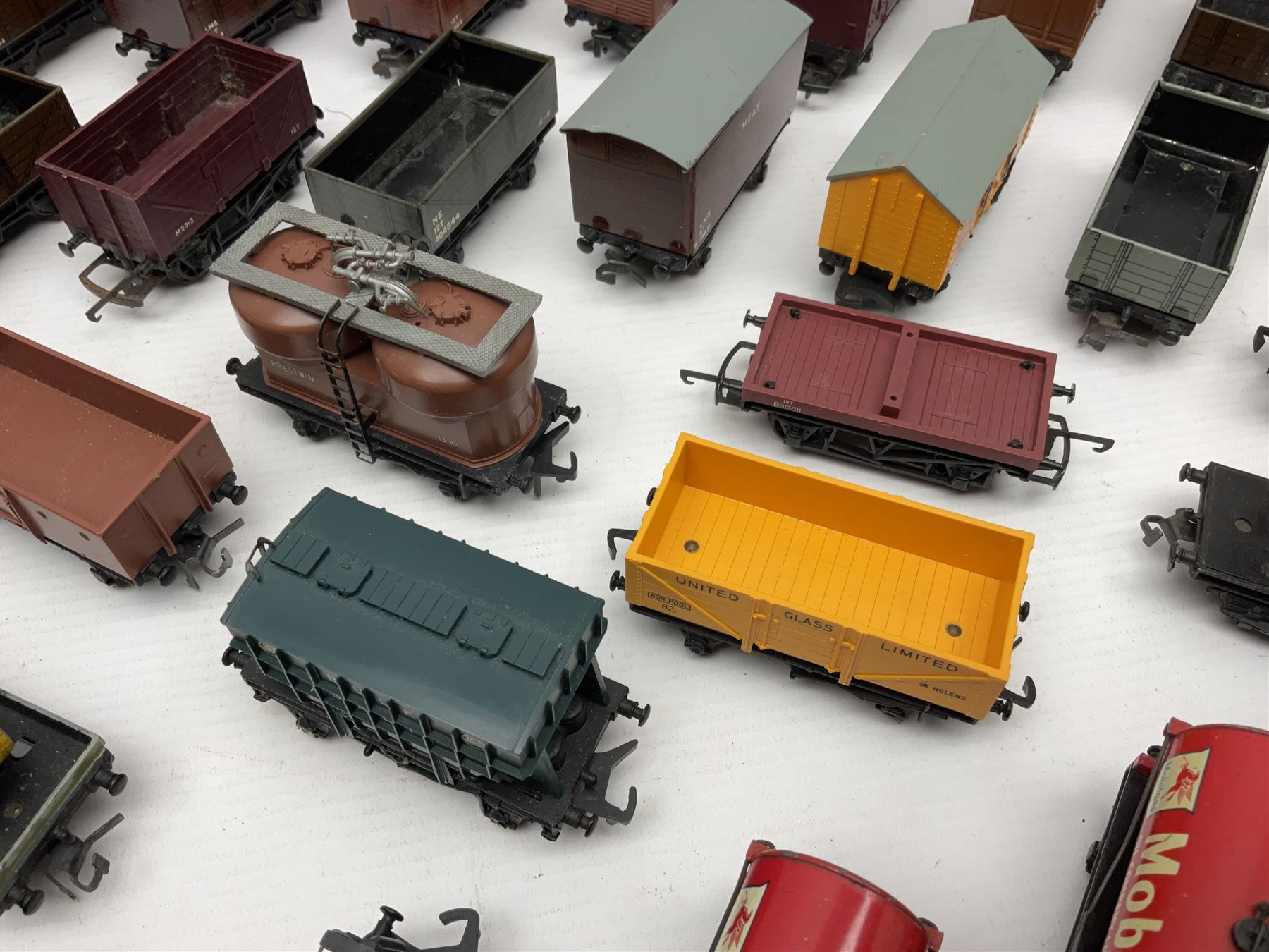 Hornby Dublo - forty-three goods wagons including nine tank wagons (Esso, Mobil, Vacuum, UD and Traffic Services), brake vans, meat and fish wagons, bogie well and bolsters, cable drums, open wagons, salt and grain wagons, etc; and six others by Tri-ang etc; all unboxed (49)