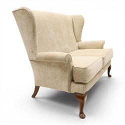 Parker Knoll - 'Hartley' lounge suite, comprising three wingback armchairs and two-seat settee, upholstered in cream fabric, shaped wing backs with scroll-over arms and loose seat cushions, on cabriole supports with pad feet wingbacks and settee

Armchairs: H 96cm, D 83cm, W 75cm
