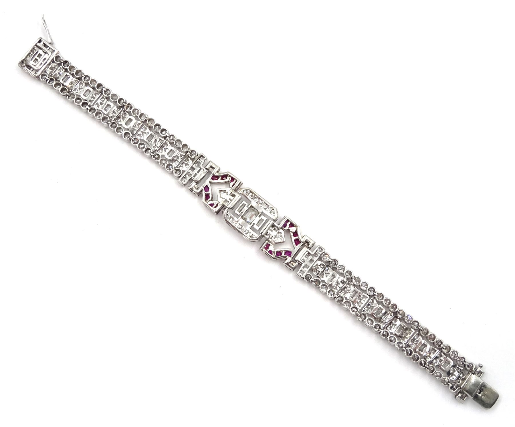 Art Deco platinum diamond and ruby bracelet, circa 1920-1930, the central panel set with a single emerald cut diamond of approx 0.55 carat, flanked by two baguette cut diamonds and old cut diamond surround, the articulated geometric design bracelet with vari-cut rubies, round and baguette cut diamonds, total diamond weight approx 7.00 carat, in Mappin & Webb silk and velvet lined box