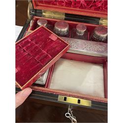  Victorian brass inlaid rosewood dressing table box, retailed by F.L. Hausburg, Liverpool, the lid centred by a brass cartouche, opening to reveal letter store to lid underside, above a fitted interior, with ten mounted cut glass jars, bottles and manicure set, within lift out leather trays, above jewellery drawer, with key, H17cm D24cm