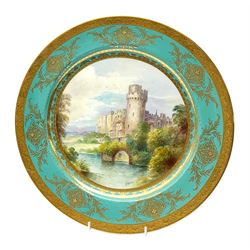 Large Minton cabinet plate, with central hand painted panel of Warwick Castle, signed A Holland, within a tooled gilt turquoise border, with impressed and printed marks and inscribed Warwick Castle beneath, D31.5cm