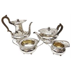Early 20th century silver four piece tea service, comprising teapot, coffee pot, twin handled open sucrier and milk jug, each of bellied form with gadrooned beaded rim with cast shell and foliate detail, the tea and coffee pots with acanthus decoration to spouts and curved wooden handles, the sucrier and milk jug with acanthus and flower head detailed curved handles, each upon four ball feet, hallmarked James Dixon & Sons Ltd, Sheffield 1918, including handles coffee pot H22.5cm teapot H15cm, approximate gross weight 76.35 ozt (2374.8 grams)

