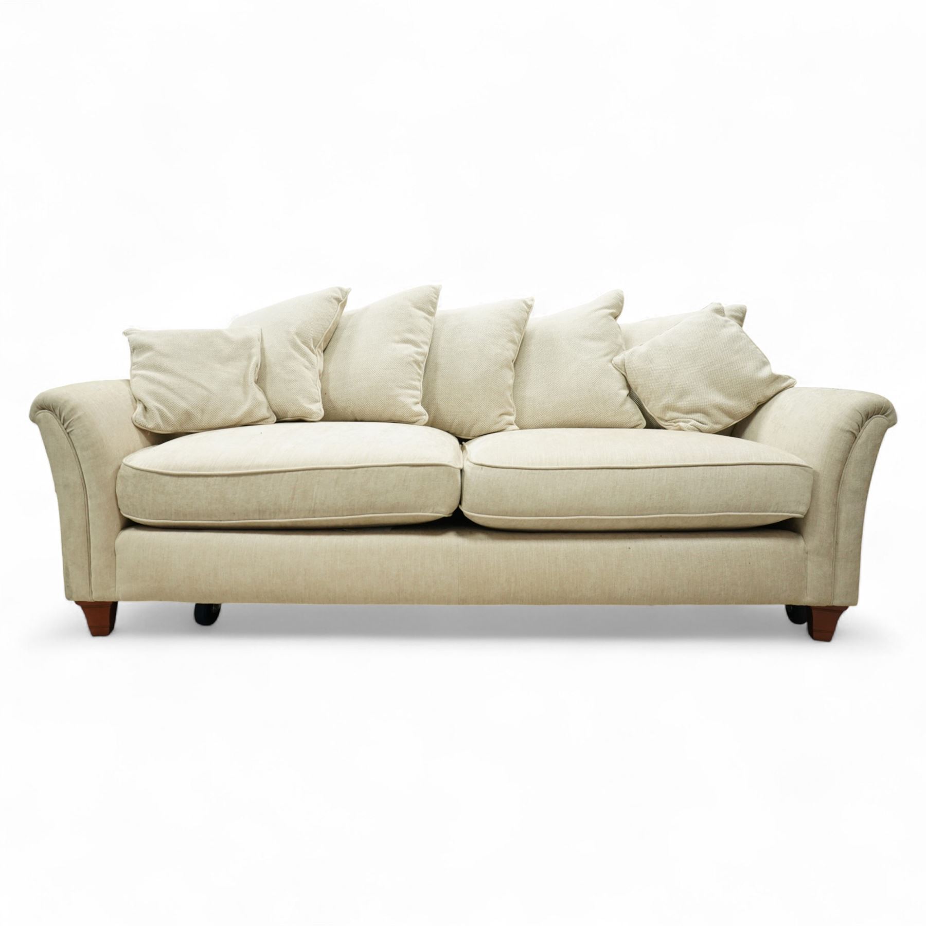 Parker Knoll - contemporary beige upholstered two seat sofa, with flared scroll arms and loose back and seat cushions, standing on stained tapered block feet