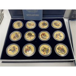 Singapore Venhonia commemorative medallion collection and a Tiger Beer commemorative three-medallion collection, both cased with certificates