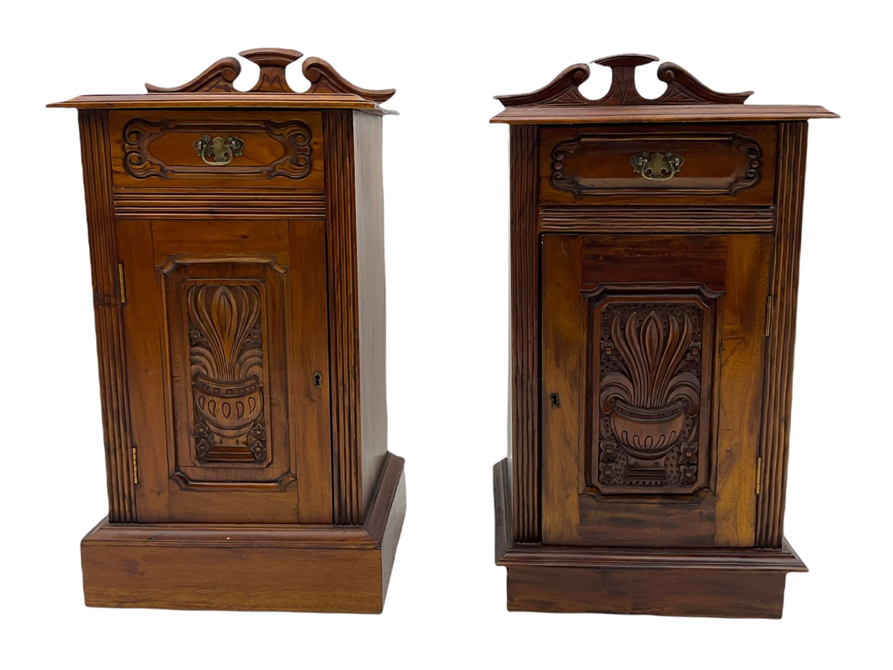 Pair Victorian style hardwood bedside cabinets, fitted with single drawer and cupboard, the doors carved with floral urns, on plinth bases