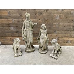 Pair of cast stone garden dogs and 2 female figures,