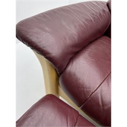 Ekornes 'Stressless' three seat sofa upholstered in cranberry leather and two matching footstoold