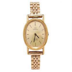 Omega ladies gold-plated quartz wristwatch, gilt dial with baton hour markers, on 9ct gold...