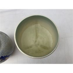 1930s Carlton Ware Art Deco Garden pattern vase of shouldered ovoid form, decorated with blue, pink and yellow flower heads on a mottled blue and white ground, pattern no. 3413, with printed and painted marks beneath, H19cm, together with a Clarice Cliff My Garden pattern vase, raised upon three feet with blue, pink and purple moulded Hollyhock design, H20cm, with Clarice Cliff Wilkinson Ltd England marks beneath