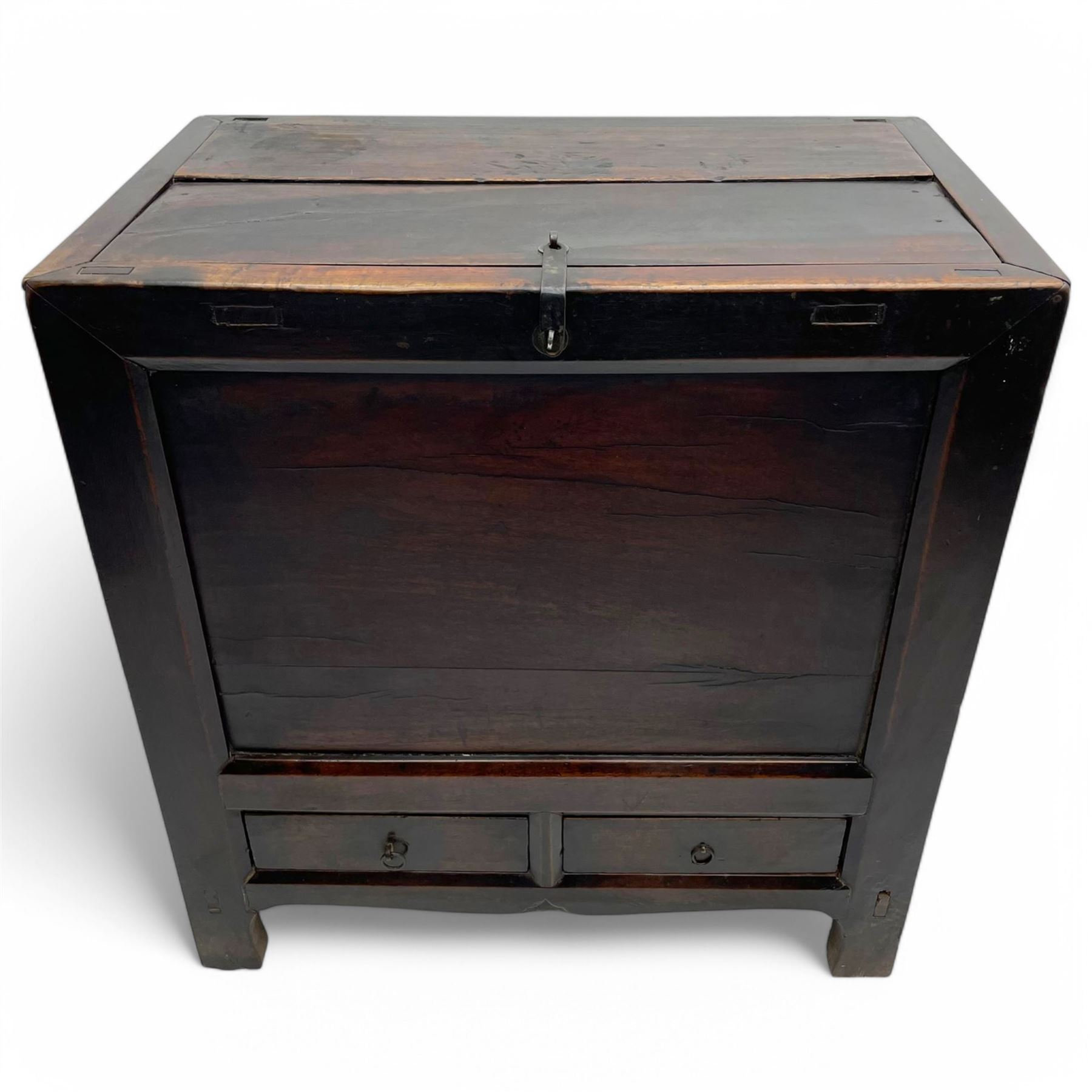 17th to 18th century Chinese fruitwood chest, possibly Gansu region, the lift-up lid with an iron strap set with two Chinese 'cash' coins, panelled front, sides and back, fitted with two small drawers, stile supports with shaped lower rail