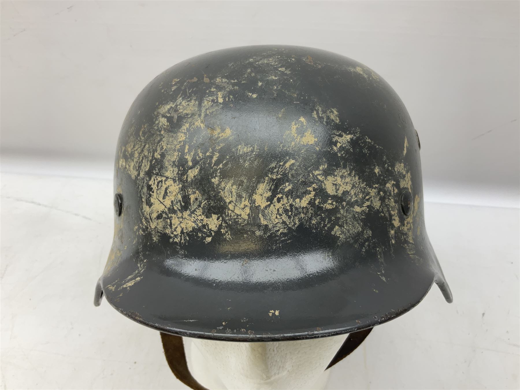 WW2 German steel helmet painted in undecaled Luftwaffe bluey grey with leather liner and chin strap stamped '58', the skirt impressed '1250'