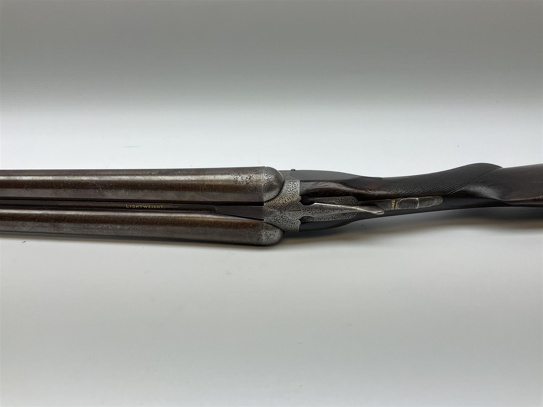 Lincoln Jeffries 12-bore side-by-side double barrel lightweight boxlock non-ejector sporting gun,  out-of-proof 66cm damascus barrels with sunken ribs, profusely engraved action, Prince of Wales walnut stock with chequered pistol grip and fore-end and thumb safety, sling swivels under barrel and stock, serial no.2139(?), L107.5cm overall RFD ONLY