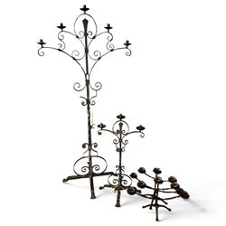 Collection of wrought iron candle stands, comprising five-light and three-light floor-stan...