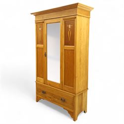 Art Nouveau oak wardrobe, central mirrored door flanked by panels inlaid with stylised tulip motifs, fitted with hanging rail and hooks, single drawer to base with brass handles