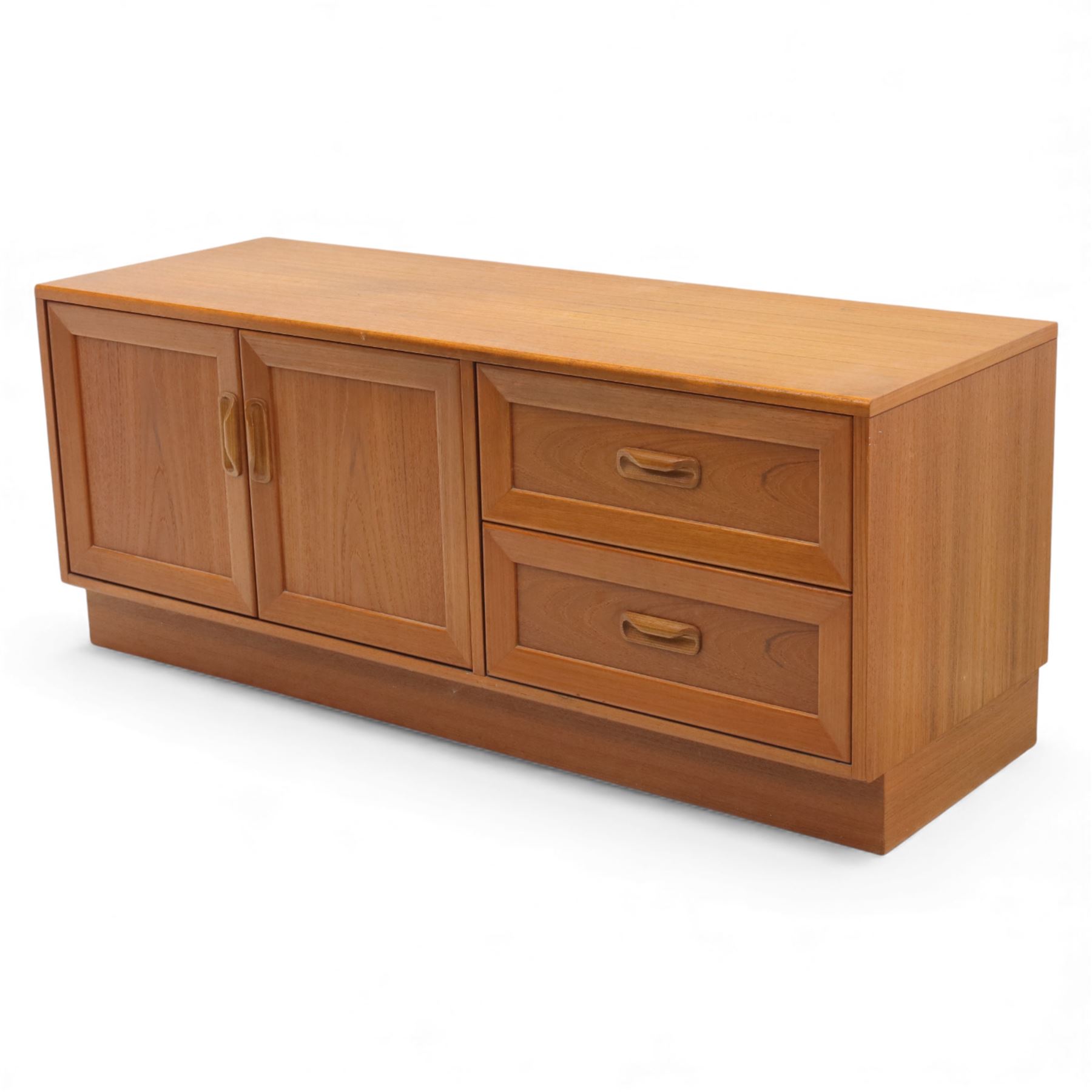 G Plan - 'Fresco' teak side unit, rectangular top above twin cupboard doors and two drawers, drawers fitted with cassette tape storage and a fall front drawer, raised on a plinth base