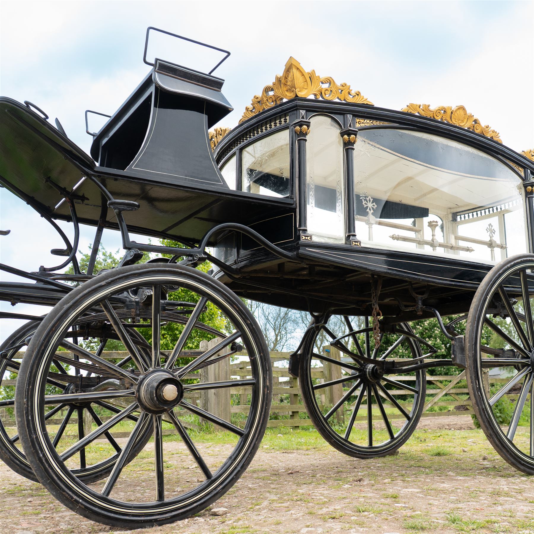 Victorian Glass Hearse

A black painted four wheeled horse drawn glass hearse with extensively glazed coffin compartment, etched glass side and end panels, decorative gilt cresting, gilt column capitals, white painted interior bier deck, metal coffin rails with cross finials, rear glazed access doors, external coachman's box seat for two, wooden spoked wheels the wheel hubs stamped 'The Economic Funeral Co', leaf spring suspension, underbody turntable steering and pole for driving with a pair of horses. The hearse has decorative painted lining throughout and an ornate black and gilt body with curved glass panels to the sides and rear.

Features

• Extensively glazed coffin compartment
• Etched glass side and end panels
• Decorative gilt cresting
• Gilt column capitals
• White painted interior bier deck
• Metal coffin rails with cross finials
• Rear glazed access doors
• External coachman's box seat
• Wooden spoked wheels
• Leaf spring suspension
• Underbody turntable steering
• Pole for driving with a pair of horses
• Decorative painted lining

Dimensions:
Overall length: 406 cm
Body length: 250 cm
Overall width: 190 cm
Body width: 115 cm
Height: 228 cm

Wheel Diameters:
Front wheels: 102 cm
Rear wheels: 133 cm

Seating

Coachman's box seat: 2