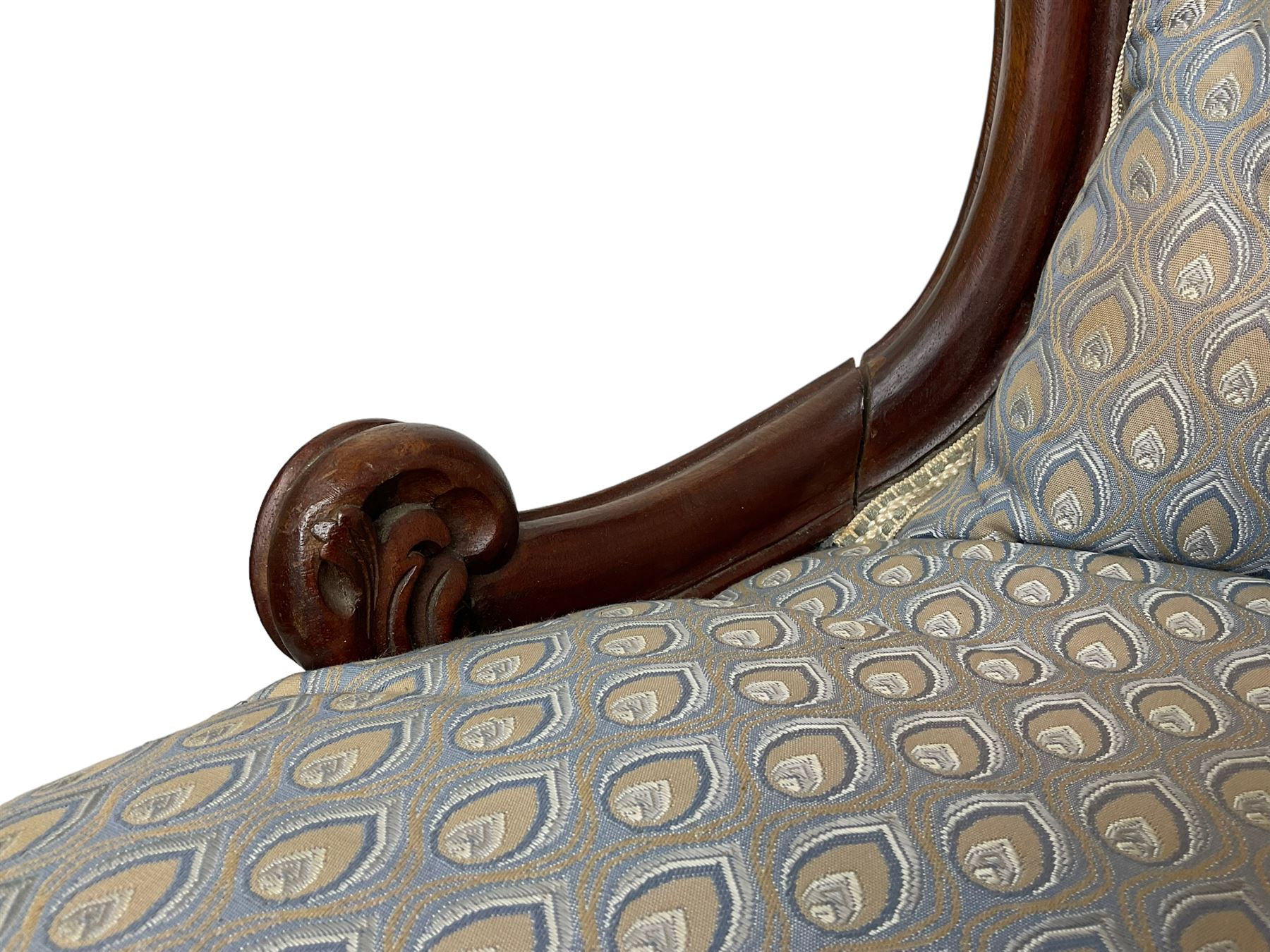 Victorian walnut framed open armchair, scrolled arm terminals over spiral turned arm supports, upholstered in foliate patterned fabric with sprung seat, on turned supports and brass castors (W65cm H92cm); and Victorian mahogany nursing chair with lobe carved supports (W60cm H92cm)