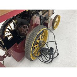 Scratch-built red and yellow painted live-steam scale model of a Showman's Traction Engine, 'Supreme' S.A. Oates & Sons, the simulated planked wooden canopy with twisted brass supports and rope light edging, 19cm flywheel, 32cm diameter rear wheels with solid rubber tyres and 21cm diameter front wheels L102cm; together with scratch-built ride-on two-wheel trailer L58cm, Franzus step-down transformer and various brass rally plaques for 1980s/1990s