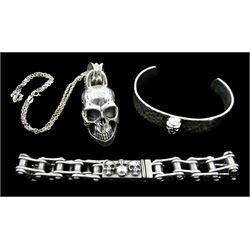 Silver skull pendant necklace, silver bike chain bracelet with skull clasp and detail to edges and a silver beaten design skull torque bangle, all stamped or hallmarked