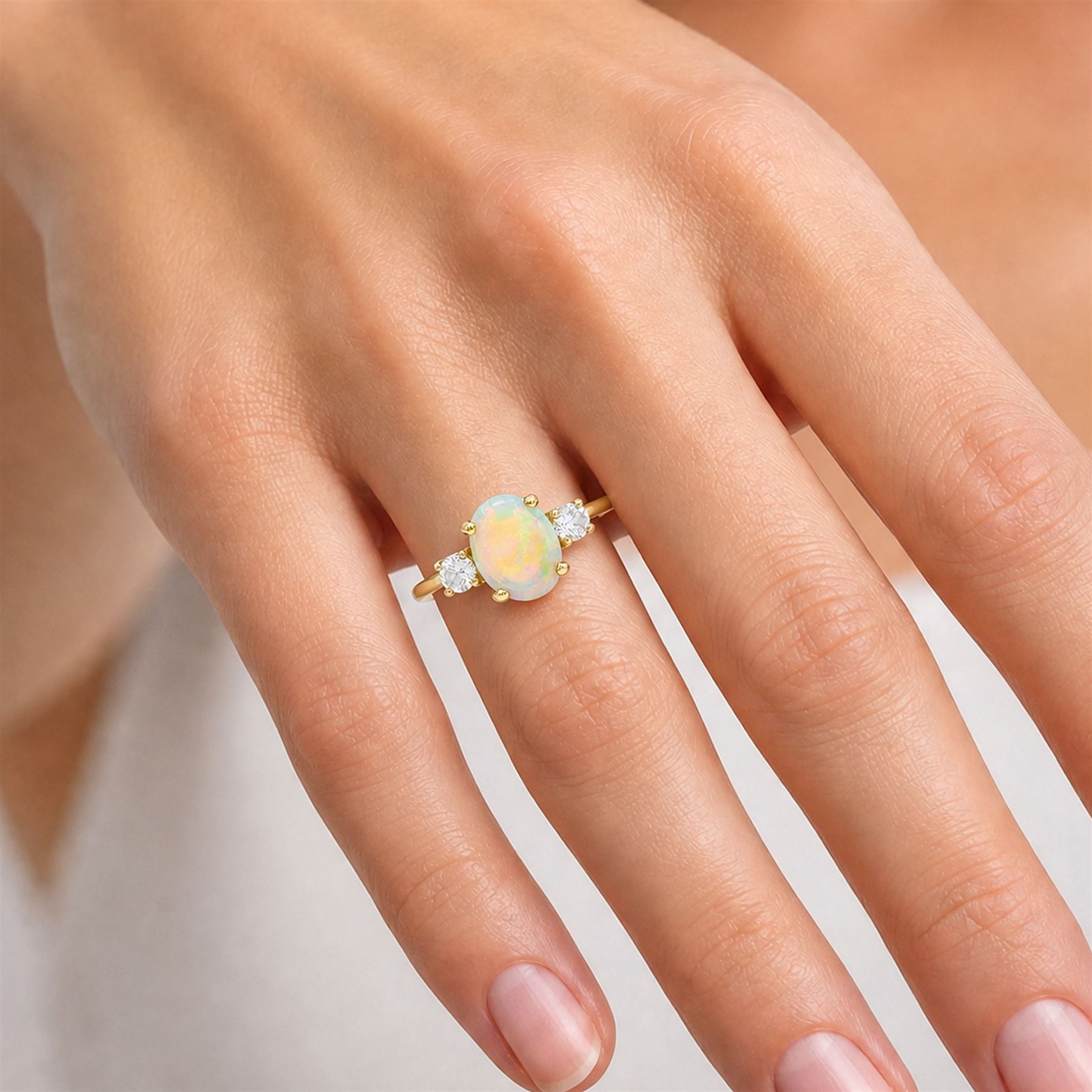 18ct god opal and diamond three stone ring, single oval cabochon cut opal of approx 2.80 carat, with a round brilliant cut diamond set either side, hallmarked, total diamond weight approx 0.25 carat