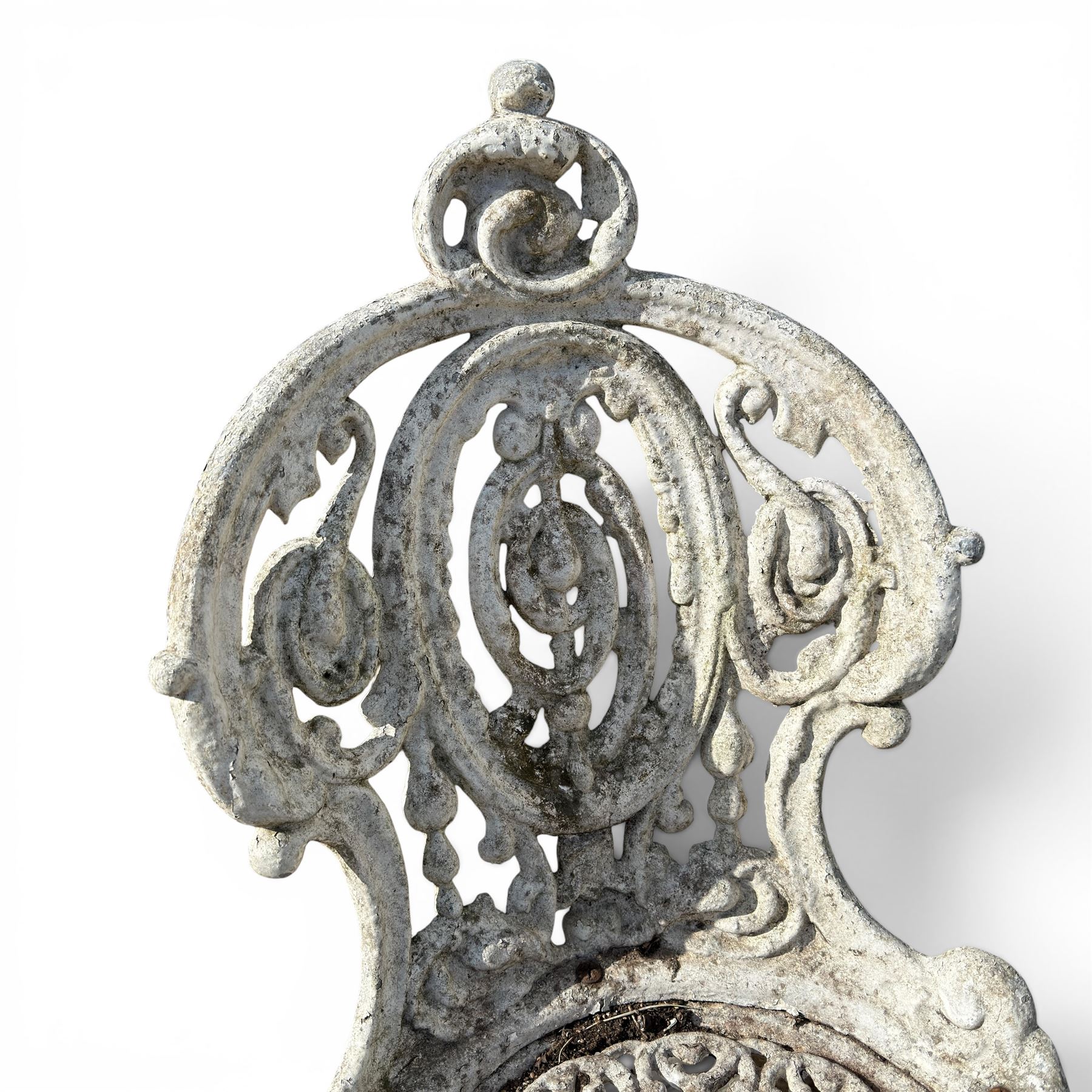 Pair of white painted cast metal garden chairs, ornate reclined backs, circular pierced seats on cabriole legs