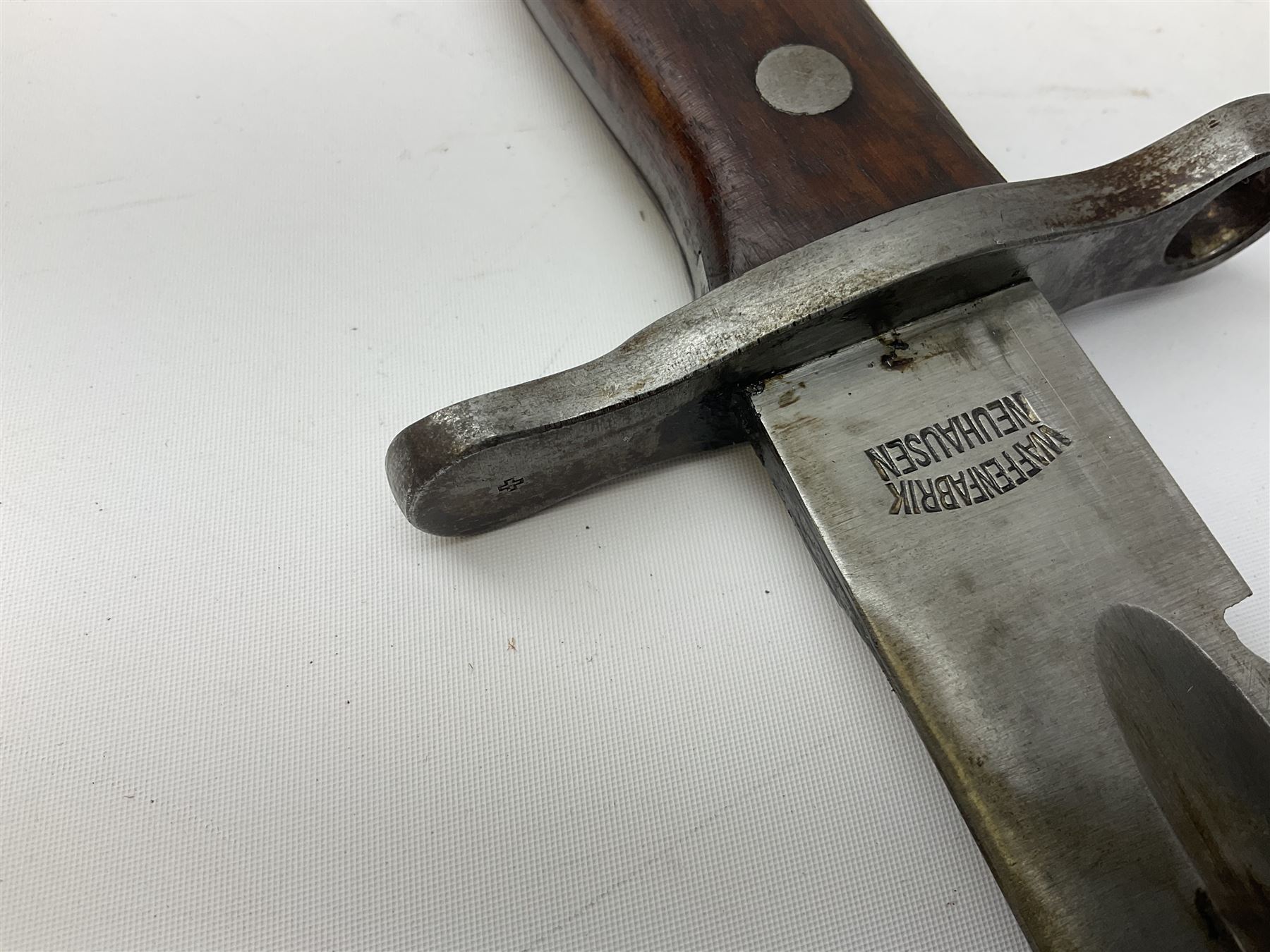 Swiss Schmidt-Rubin M1914 pioneer bayonet, with 48cm steel saw-back blade, the ricasso stamped, ''Waffenfabrik, Neuhausen'', the crosspiece stamped Swiss cross, steel scabbard, leather frog L64cm overall